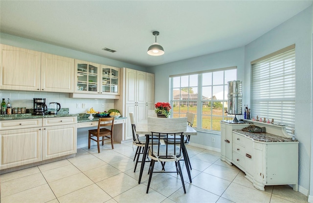 dining area with baseboards and light tile patterned flooring