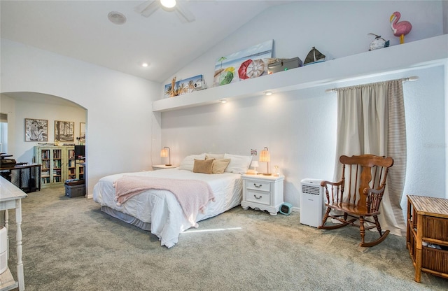 carpeted bedroom featuring vaulted ceiling, arched walkways, and a ceiling fan