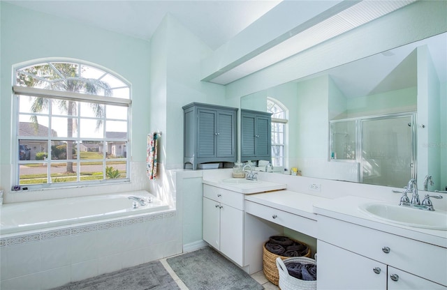 full bath featuring a shower stall, a bath, double vanity, and tile patterned flooring