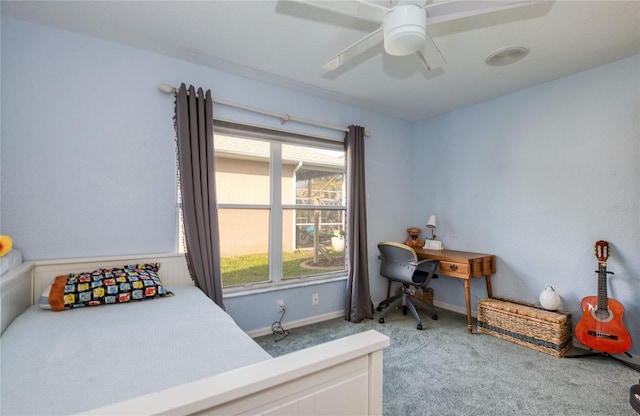 carpeted bedroom featuring baseboards and a ceiling fan