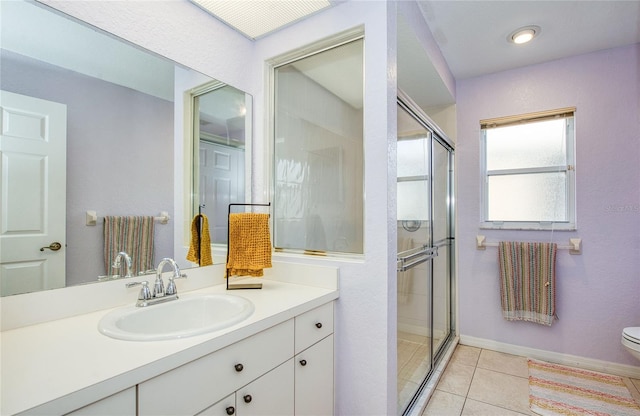 full bathroom featuring a shower stall, toilet, vanity, and tile patterned floors