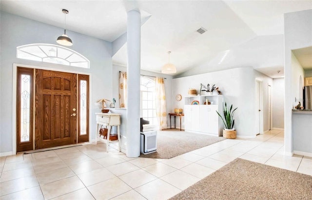 tiled entrance foyer featuring lofted ceiling and baseboards