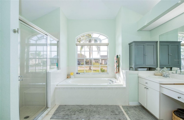 full bath with a shower stall, vanity, a bath, and tile patterned flooring