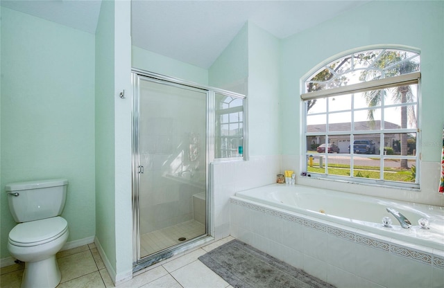 bathroom featuring a stall shower, plenty of natural light, a garden tub, and toilet