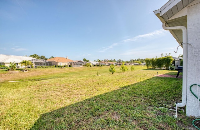 view of green lawn with a residential view
