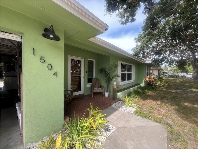 view of exterior entry with stucco siding