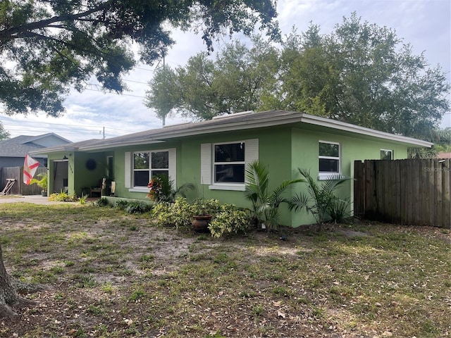 view of side of home with fence