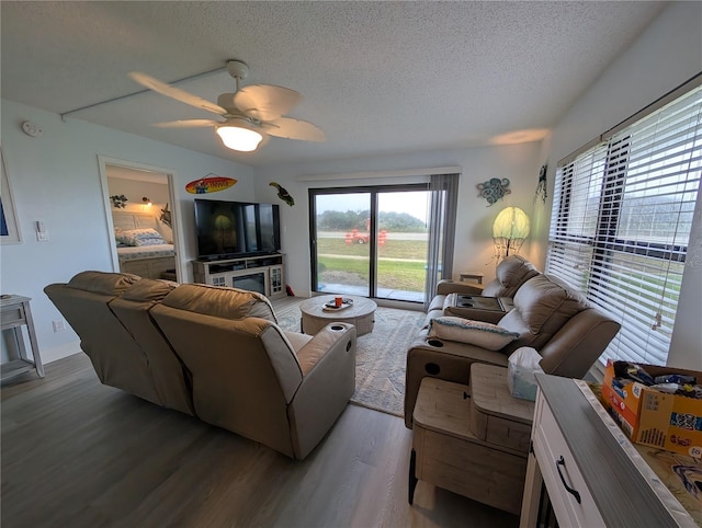 3100 Ocean Shore Blvd Unit 101, Ormond Beach, FL 32176 - living room featuring a textured ceiling, wood finished floors, and a ceiling fan