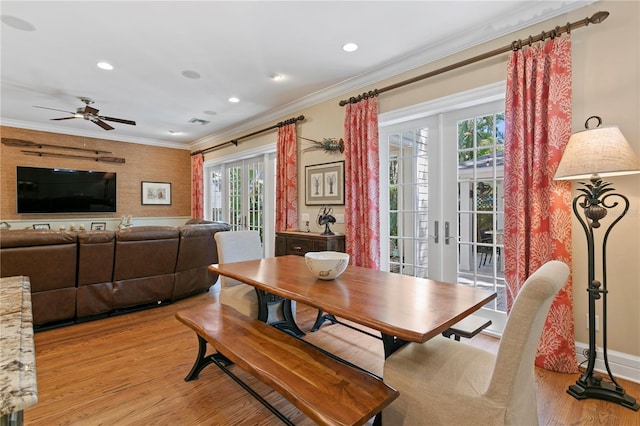 dining area featuring french doors, light wood finished floors, crown molding, a ceiling fan, and recessed lighting