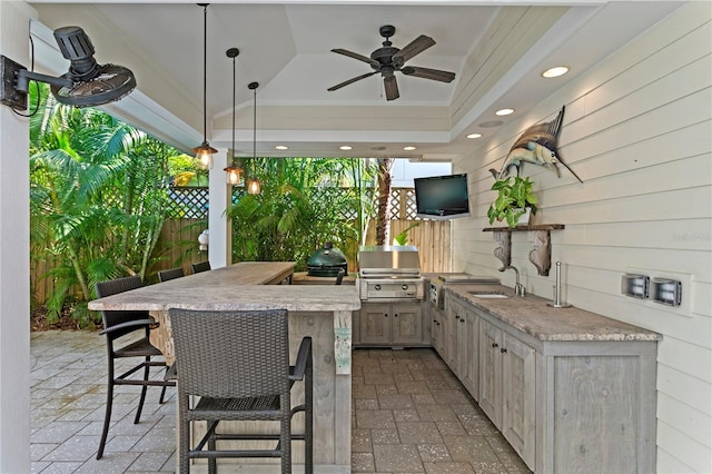 view of patio with grilling area, exterior kitchen, and ceiling fan