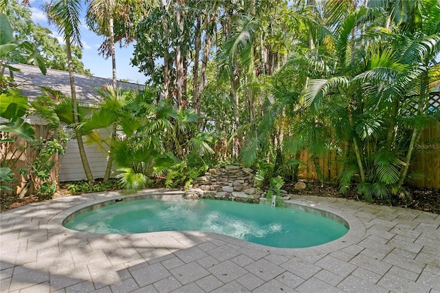 view of swimming pool with fence and a patio area