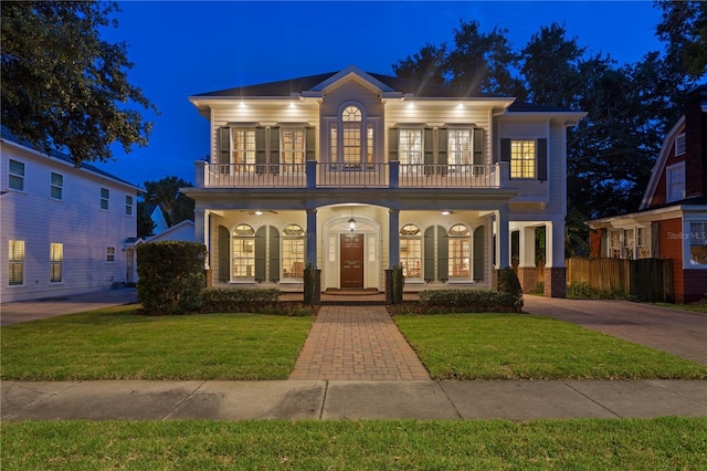 view of front facade featuring a balcony, a porch, and french doors