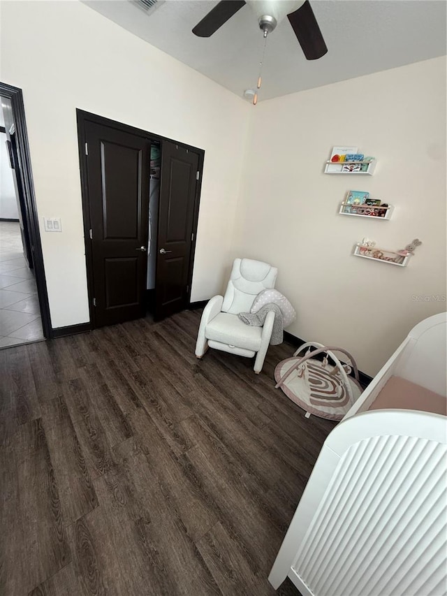 bedroom with visible vents, baseboards, ceiling fan, and wood finished floors
