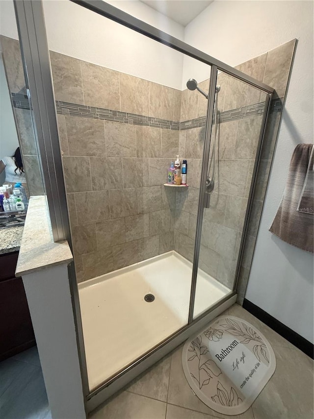 bathroom featuring tile patterned floors and a stall shower