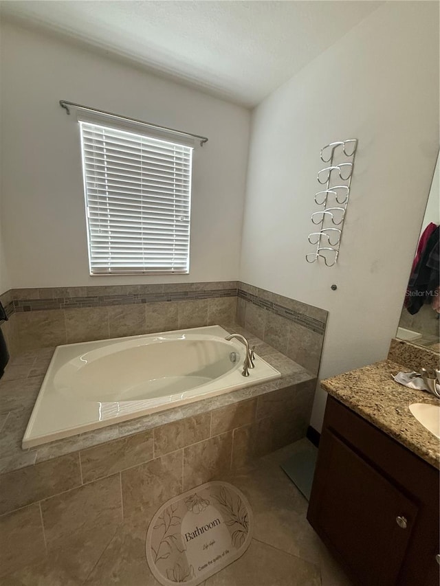 bathroom featuring vanity, a garden tub, and tile patterned floors
