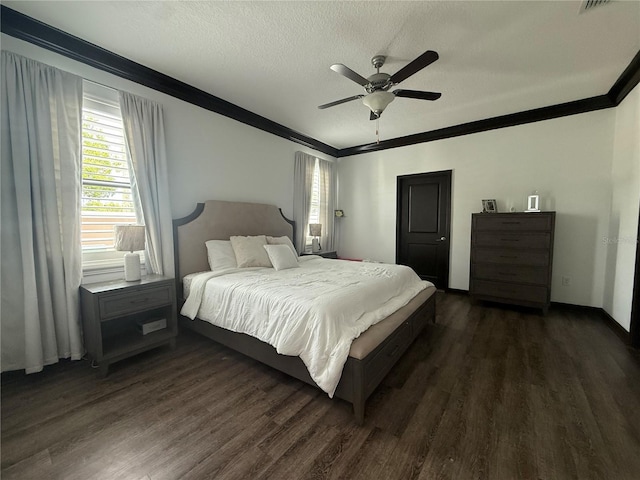 bedroom featuring ceiling fan, ornamental molding, dark wood finished floors, and a textured ceiling