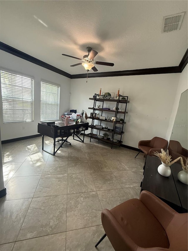 interior space featuring visible vents, ornamental molding, baseboards, and ceiling fan