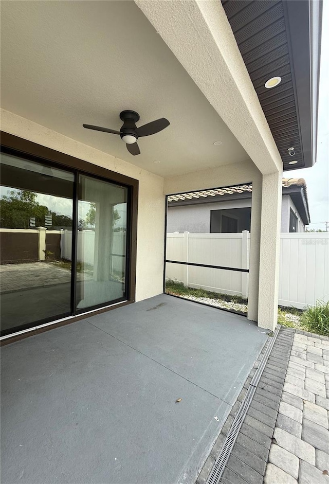 view of patio / terrace featuring fence and a ceiling fan