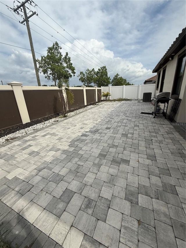 view of patio with central AC and a fenced backyard