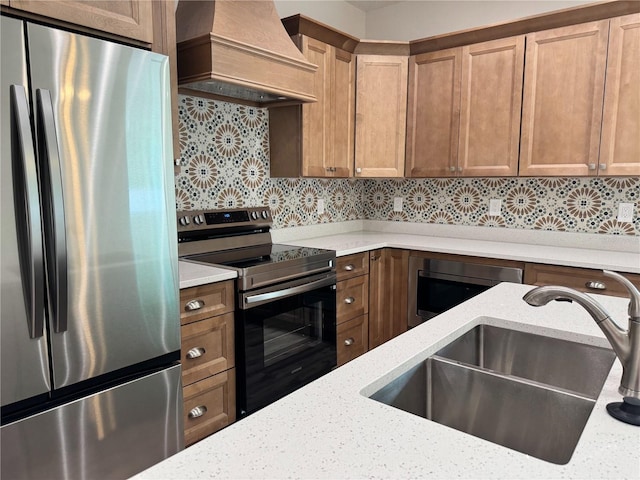 kitchen with a sink, stainless steel appliances, tasteful backsplash, custom exhaust hood, and light stone countertops