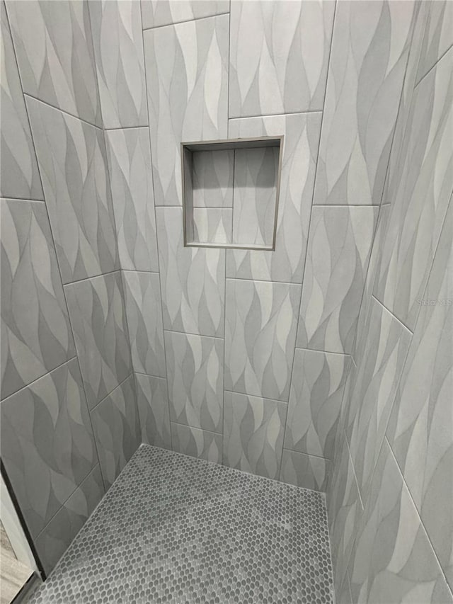 bathroom with tiled shower