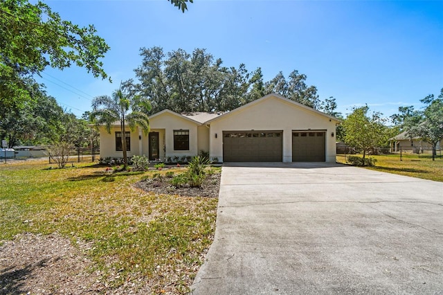 single story home featuring fence, driveway, a front yard, and a garage