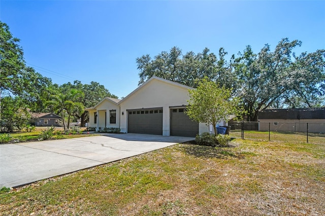 ranch-style house featuring fence, a garage, stucco siding, a front yard, and driveway