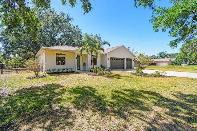 single story home with driveway, a front yard, a garage, fence, and stucco siding