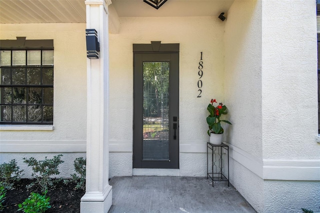 doorway to property with stucco siding