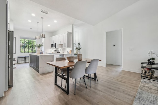 dining area with recessed lighting, baseboards, light wood finished floors, and visible vents