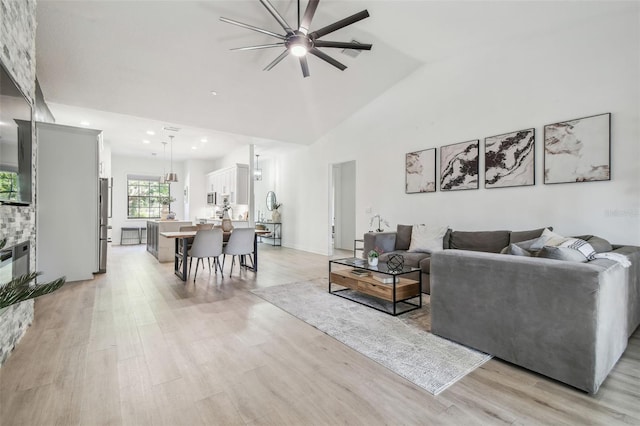 living room featuring recessed lighting, ceiling fan, and light wood finished floors
