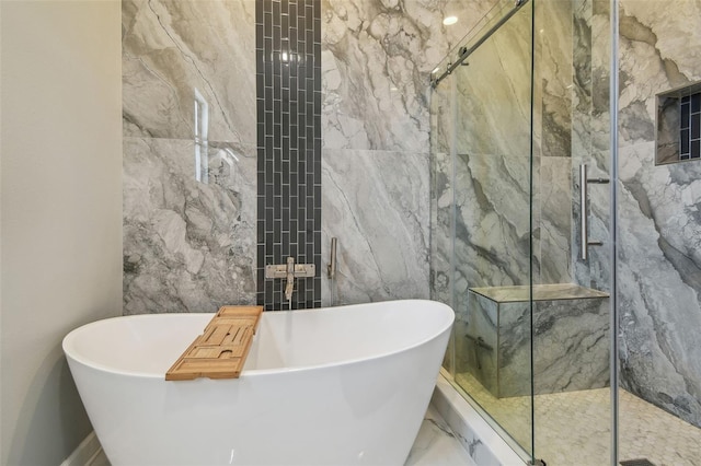 bathroom featuring a marble finish shower, a soaking tub, and marble finish floor