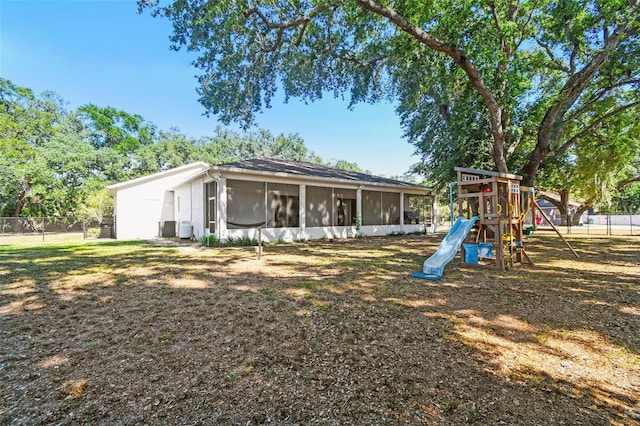 view of play area featuring fence and a sunroom