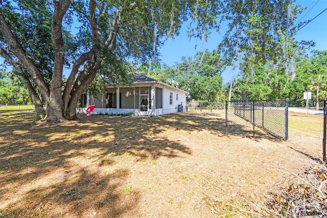 view of yard featuring fence and a sunroom