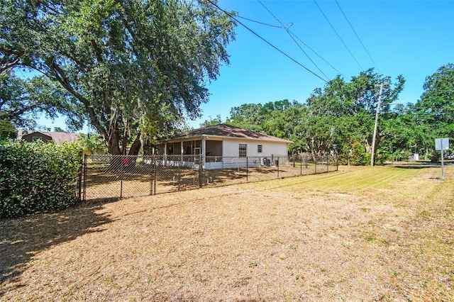 view of yard with fence and a sunroom