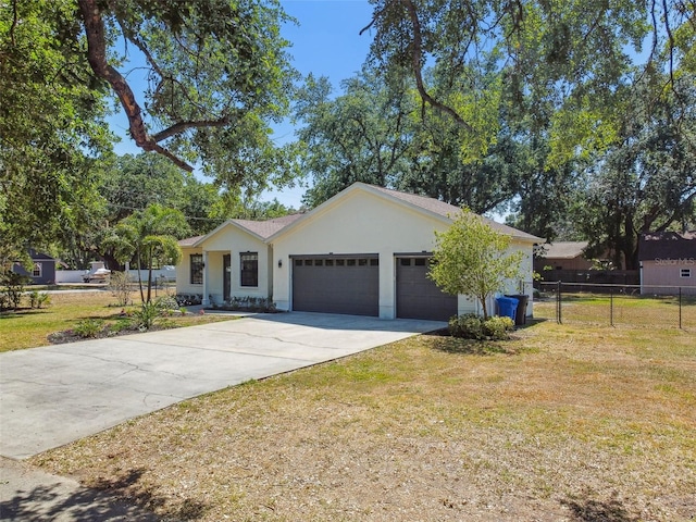 single story home with fence, a garage, stucco siding, a front yard, and concrete driveway
