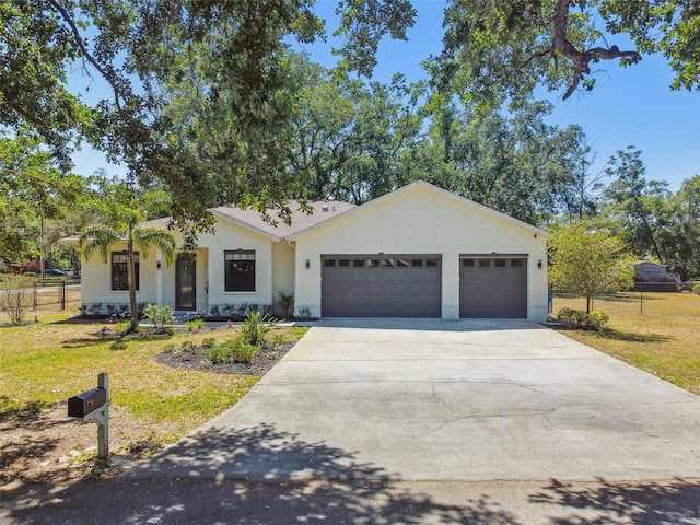 ranch-style home with an attached garage, a front lawn, stucco siding, and concrete driveway