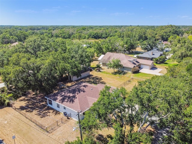 birds eye view of property with a view of trees