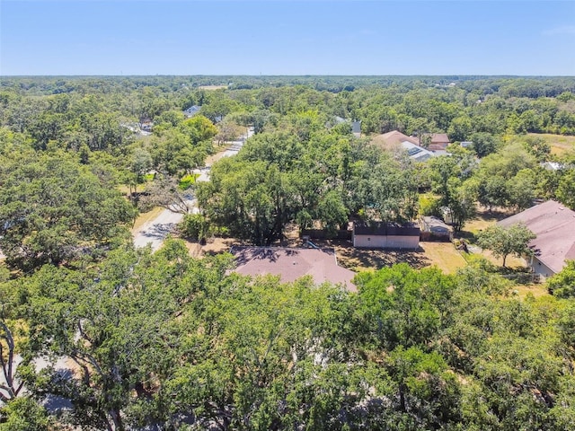 drone / aerial view featuring a wooded view