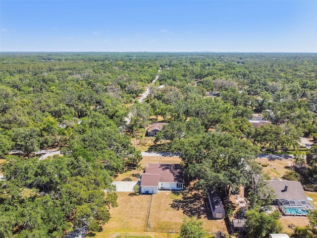 birds eye view of property with a view of trees