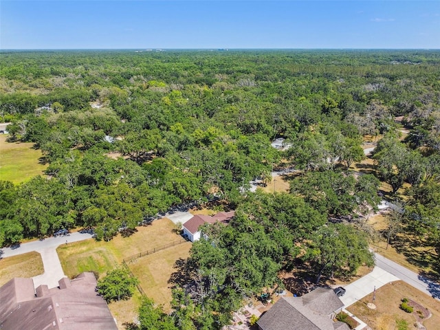 drone / aerial view featuring a forest view