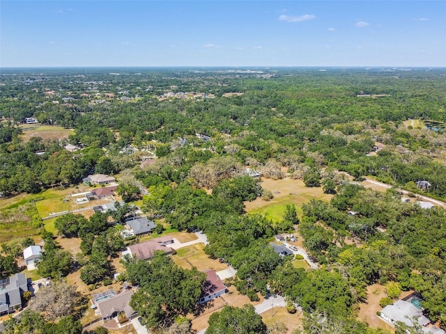 birds eye view of property featuring a forest view