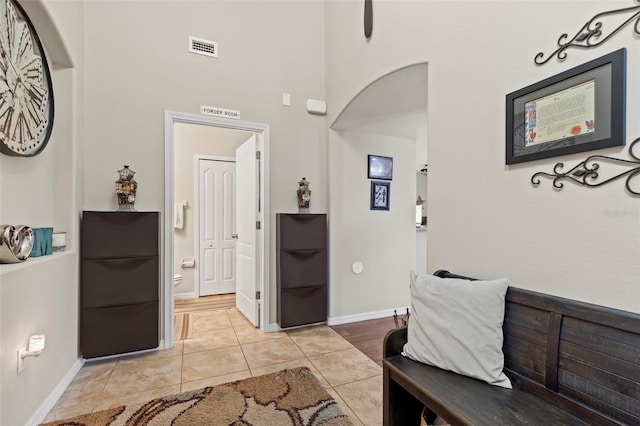 11871 Crestridge Loop, Trinity, FL 34655 - entrance foyer with light tile patterned flooring, a high ceiling, arched walkways, baseboards, and visible vents