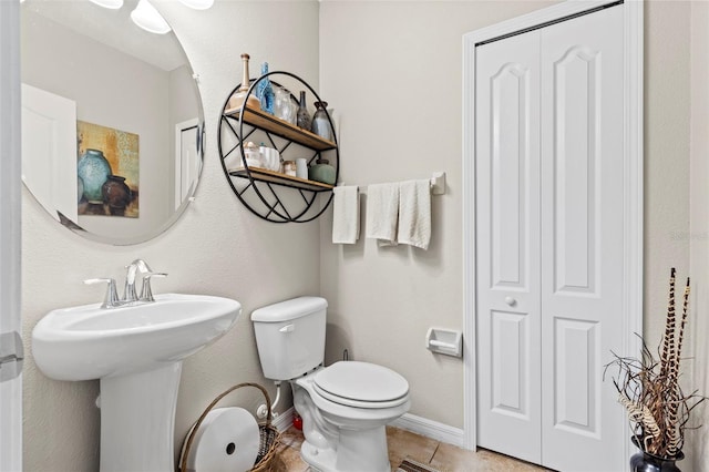 11871 Crestridge Loop, Trinity, FL 34655 - bathroom featuring a sink, tile patterned floors, baseboards, a closet, and toilet