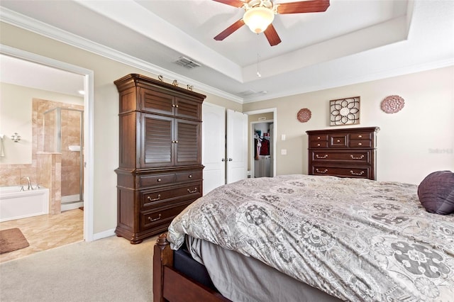 11871 Crestridge Loop, Trinity, FL 34655 - bedroom with ceiling fan, ensuite bathroom, visible vents, ornamental molding, and a tray ceiling