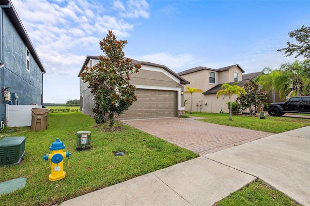 11871 Crestridge Loop, Trinity, FL 34655 - view of front of house with a garage, stucco siding, a front yard, an outbuilding, and decorative driveway