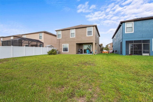 11871 Crestridge Loop, Trinity, FL 34655 - rear view of house featuring a yard, fence, and stucco siding