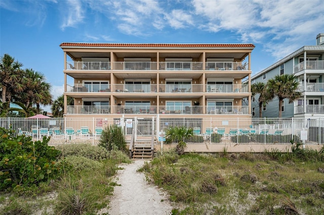 view of property with a community pool and fence