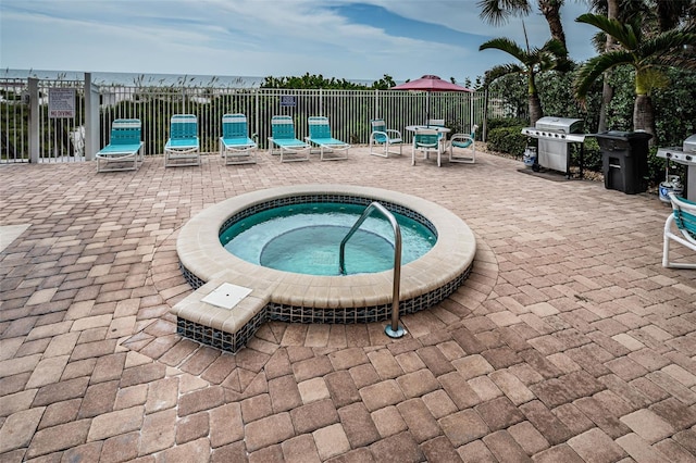 view of pool with a hot tub, a patio, fence, and a grill