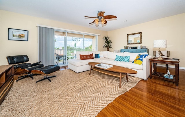 living room with a ceiling fan and wood finished floors